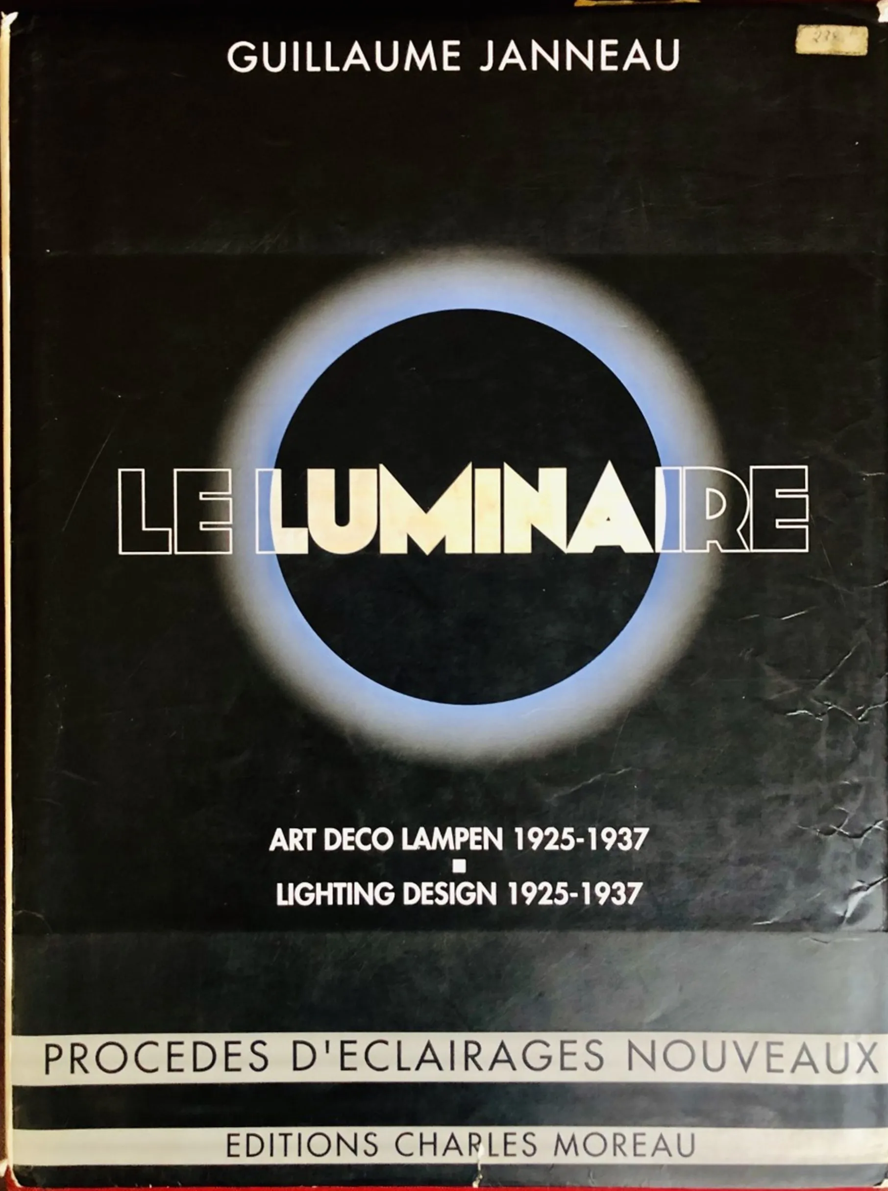Portada del antiguo libro Le Luminaire con diseño simple y moderno con un círculo azul y blanco.