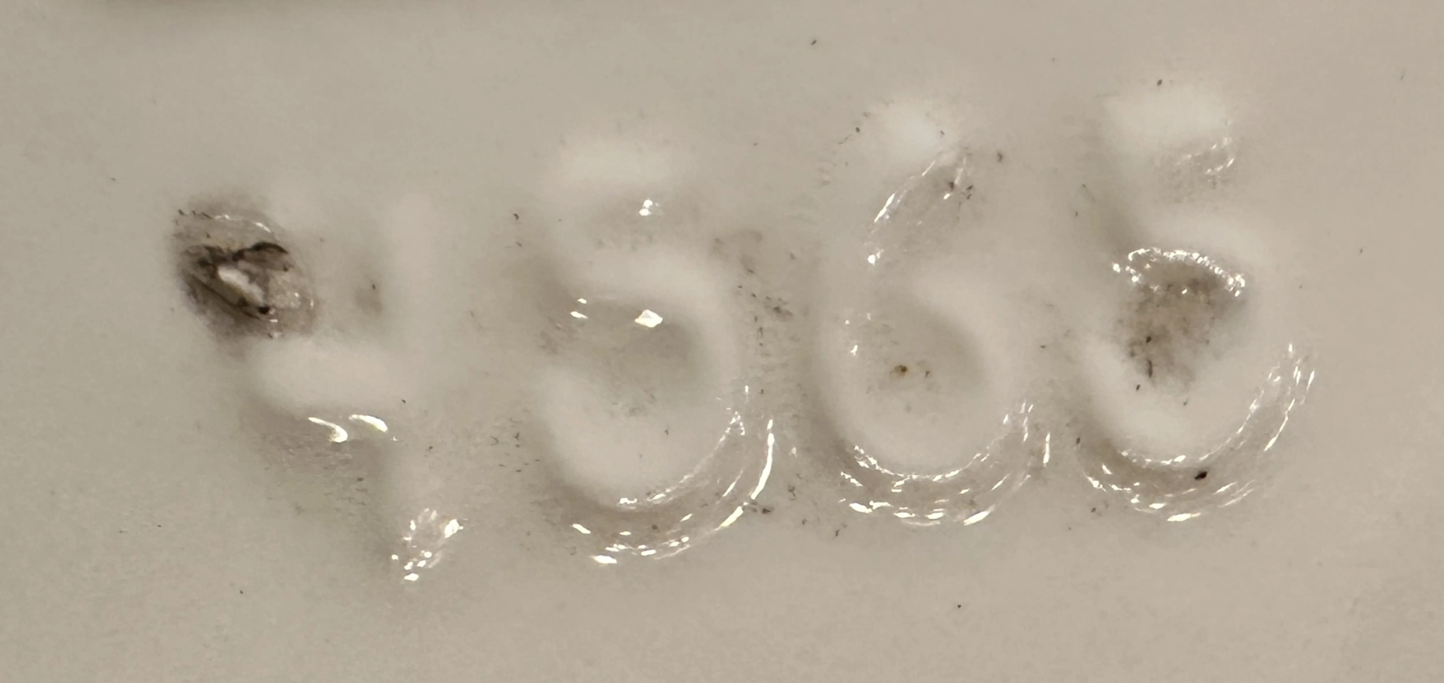 close-up of antique showing serial number 4565