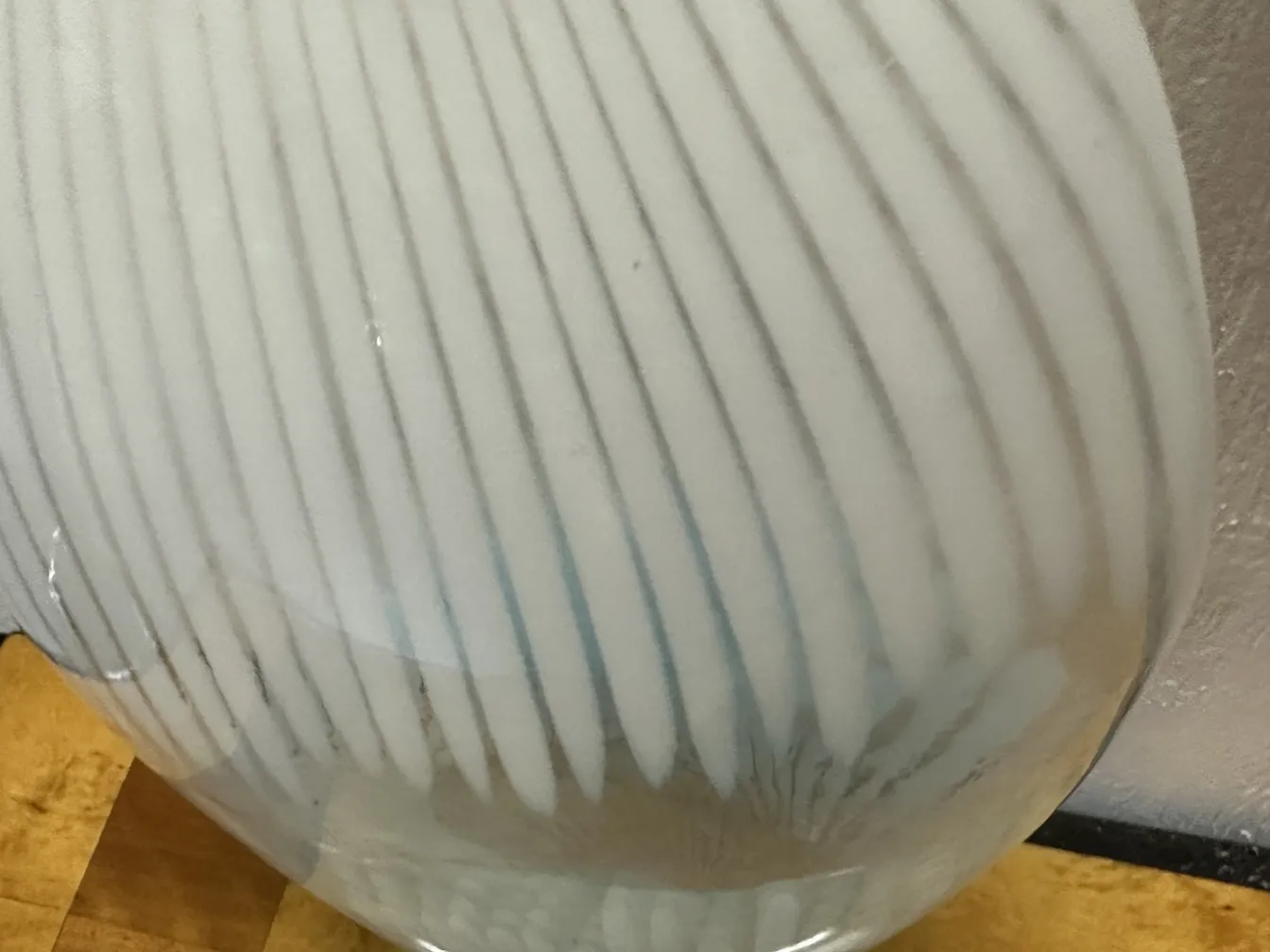 Dos floreros antiguos de estilo Murano en una mesa de madera.