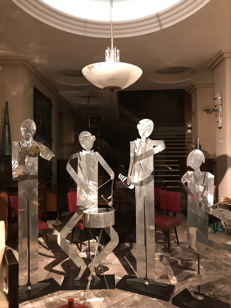 Sculptures of an antique music band by designer Marcelo Peña in a cozy setting.