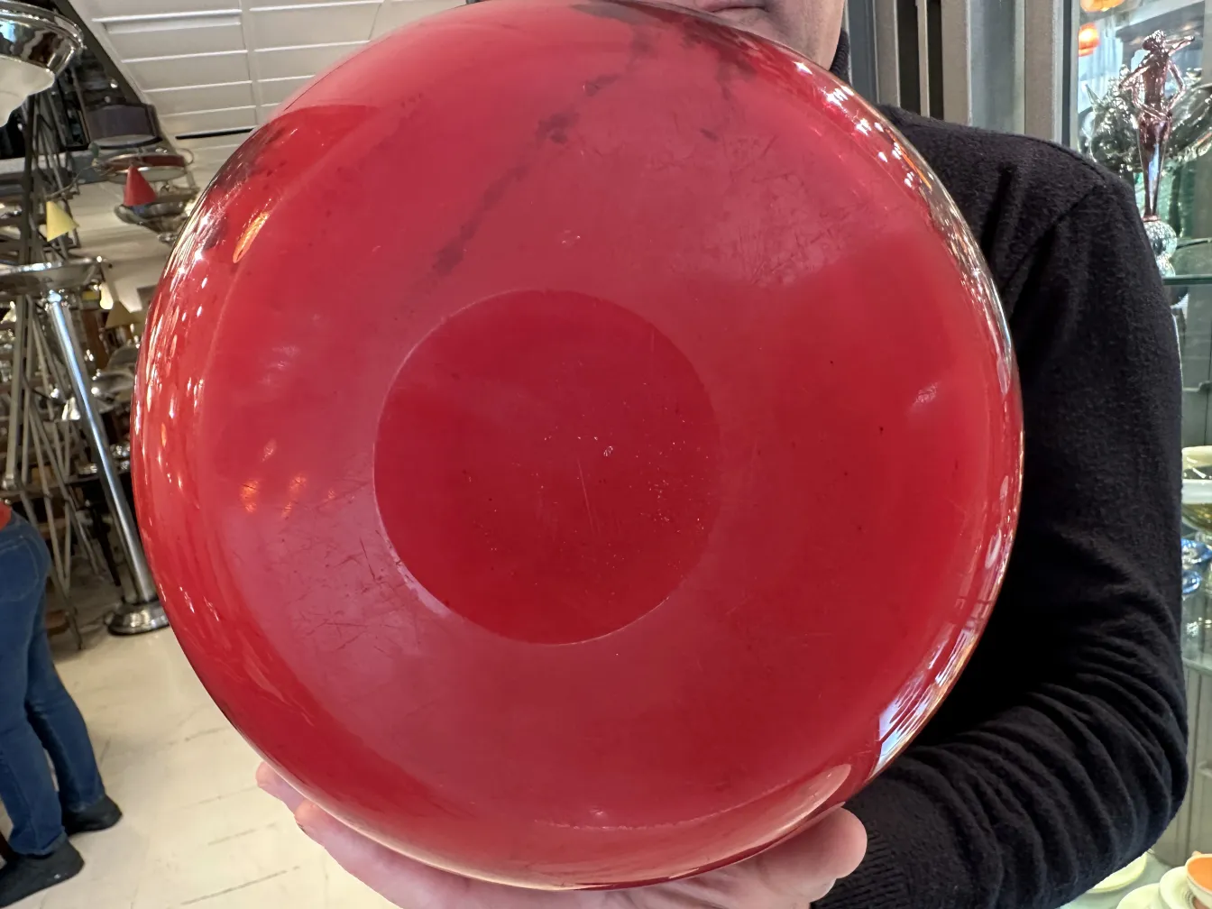 Red glass vase featuring Schneider's signature decoration