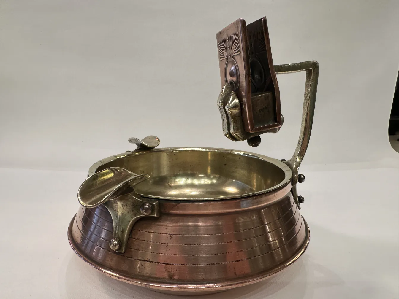 Antique ashtray on table with black surface