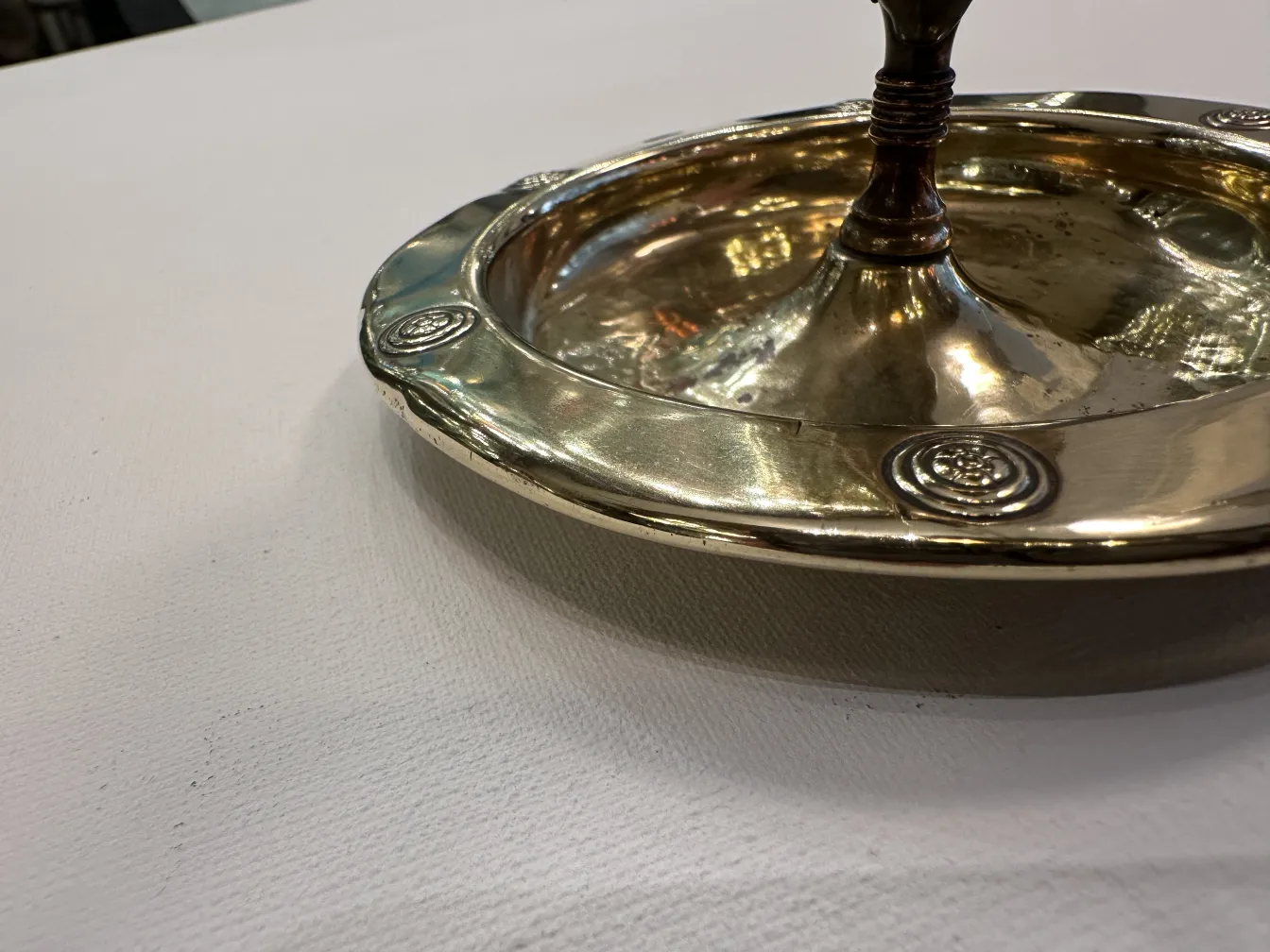 Antique WMF ashtray with decorative design and circular shape.