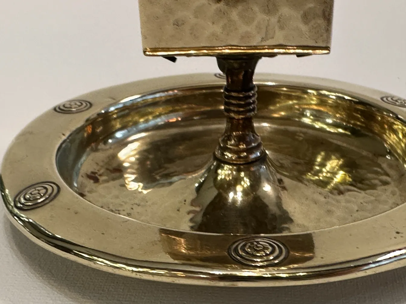 Antique WMF ashtray with decorative design and circular shape.