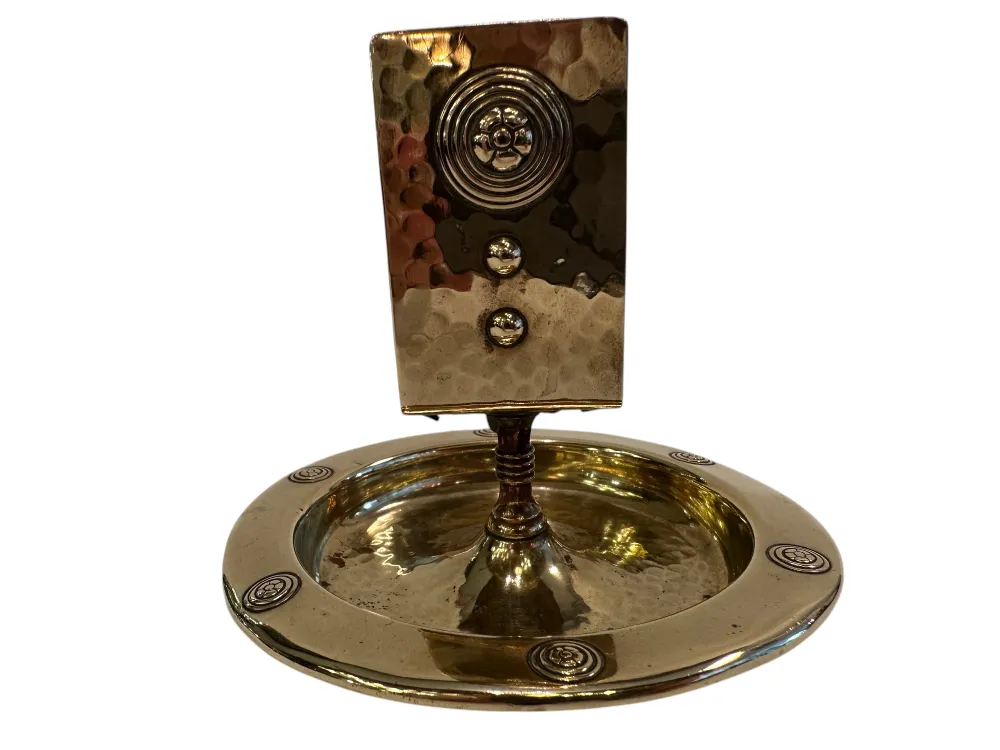 Antique WMF ashtray with decorative design and circular shape.