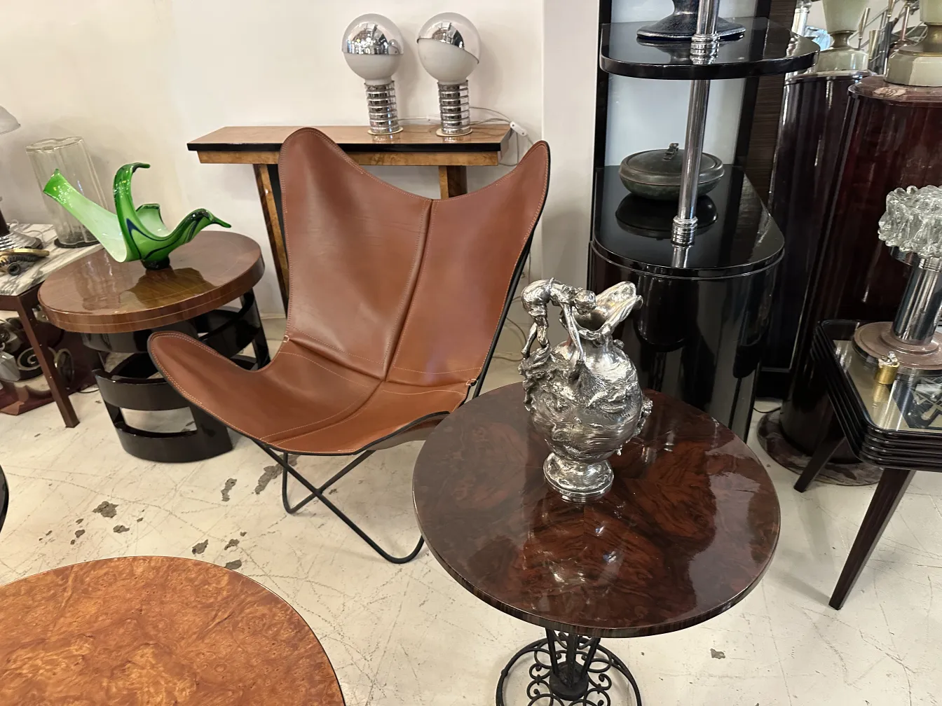 Two decorative antique jars on a table in an elegant furniture setting.