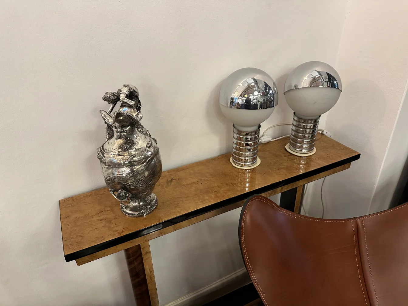 two antique jars with distinctive and elegant design, alongside modern-style lamps