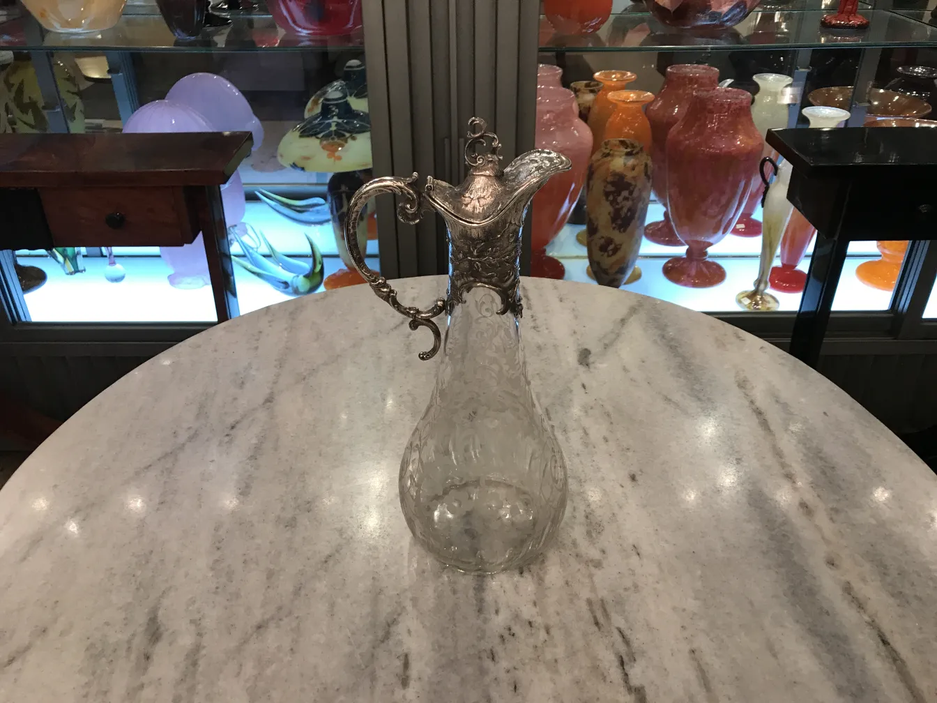 two antique WMF jars with intricate design and decorative handles, in an elegant setting