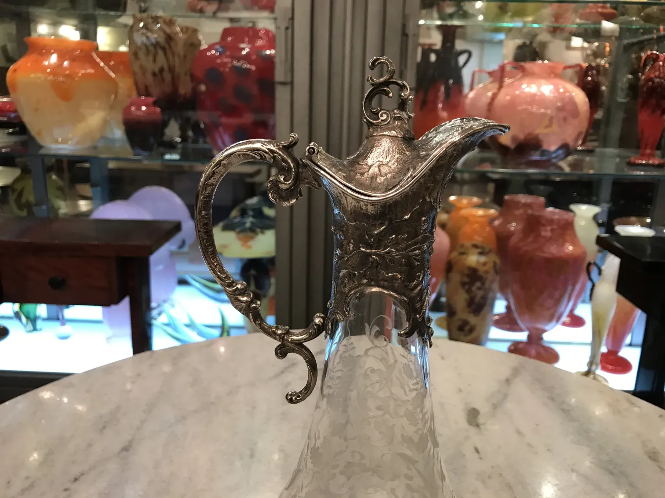 two antique WMF jars with intricate design and decorative handles, in an elegant setting