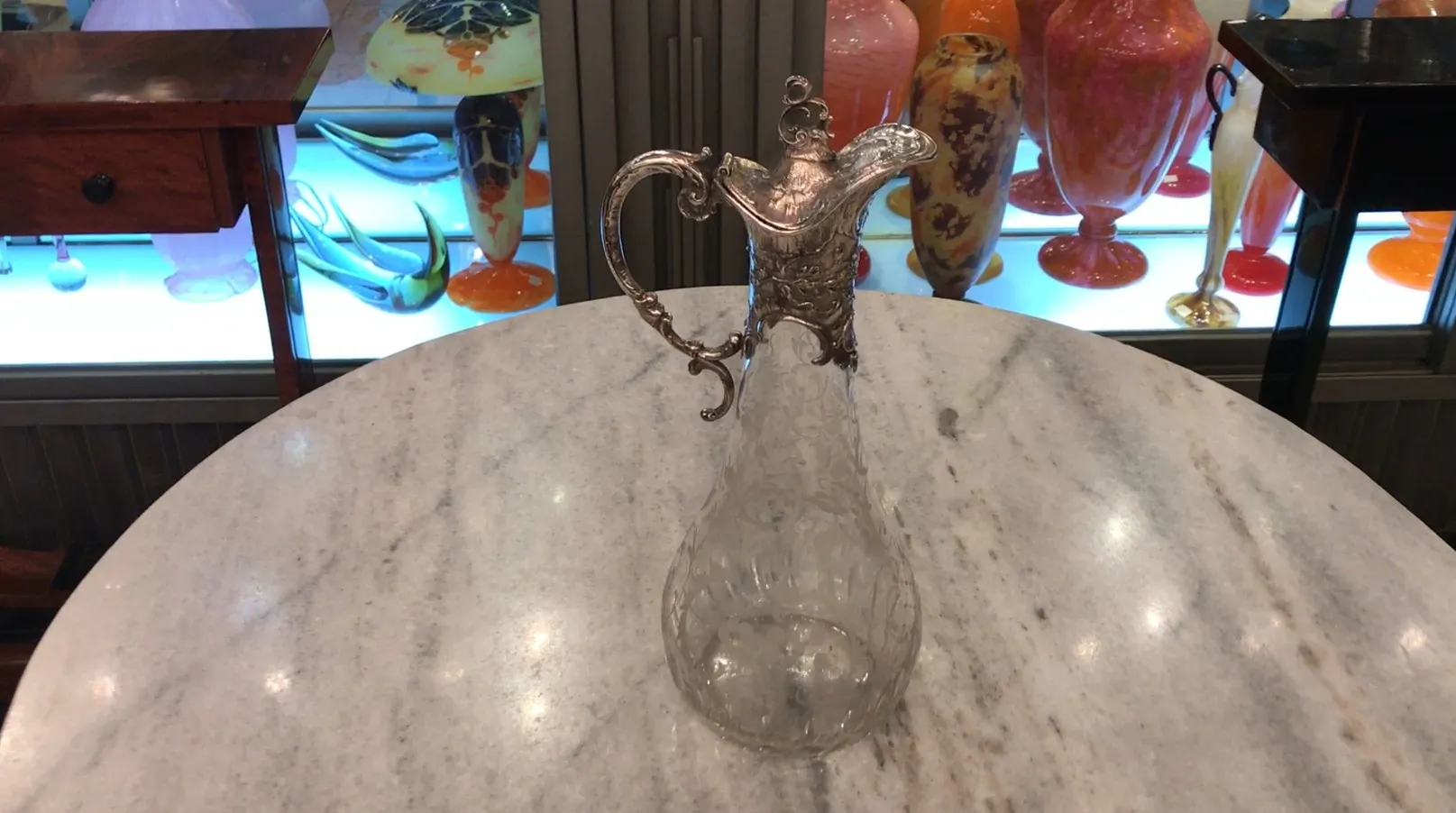 two antique WMF jars with intricate design and decorative handles, in an elegant setting