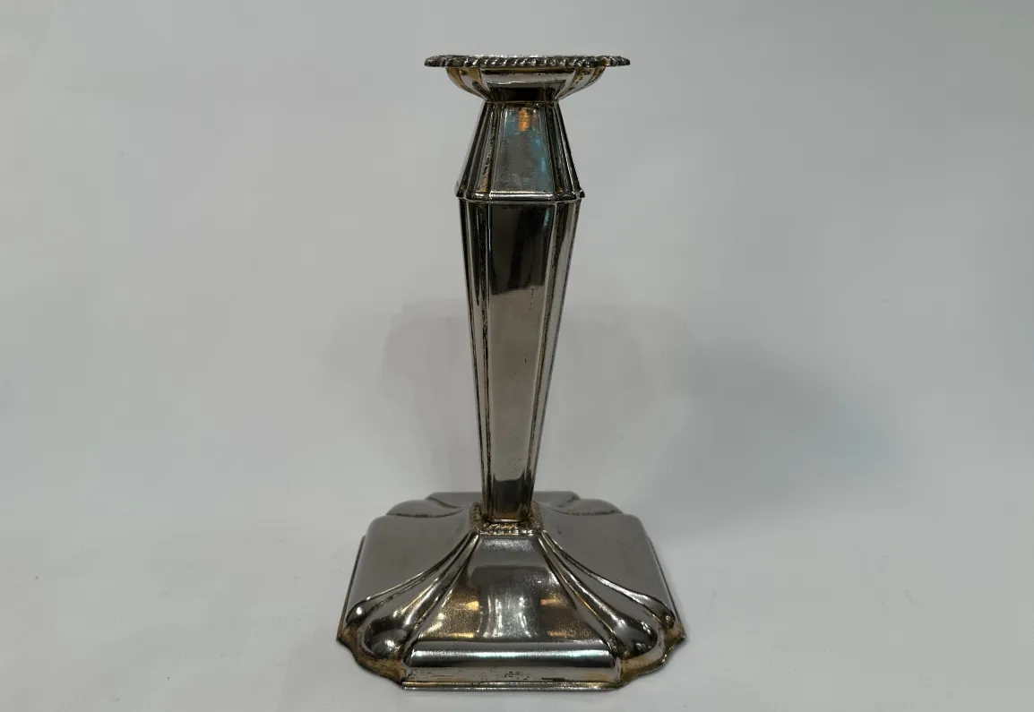 Antique decorative candelabra featuring elegant base and symmetrical design.