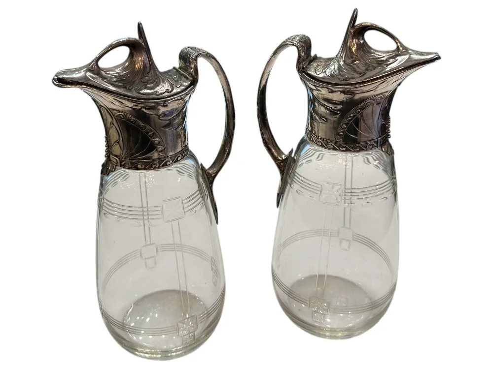 Two antique WMF jars featuring decorative details and an elegant design in a classic setting.