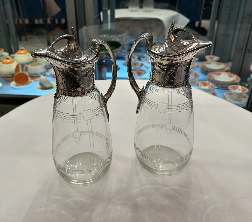 Two antique WMF jars featuring decorative details and an elegant design in a classic setting.