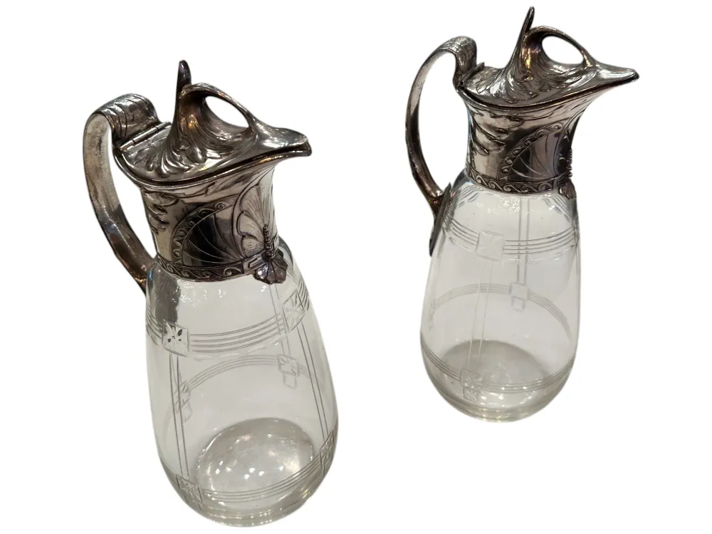 Two antique WMF jars featuring decorative details and an elegant design in a classic setting.