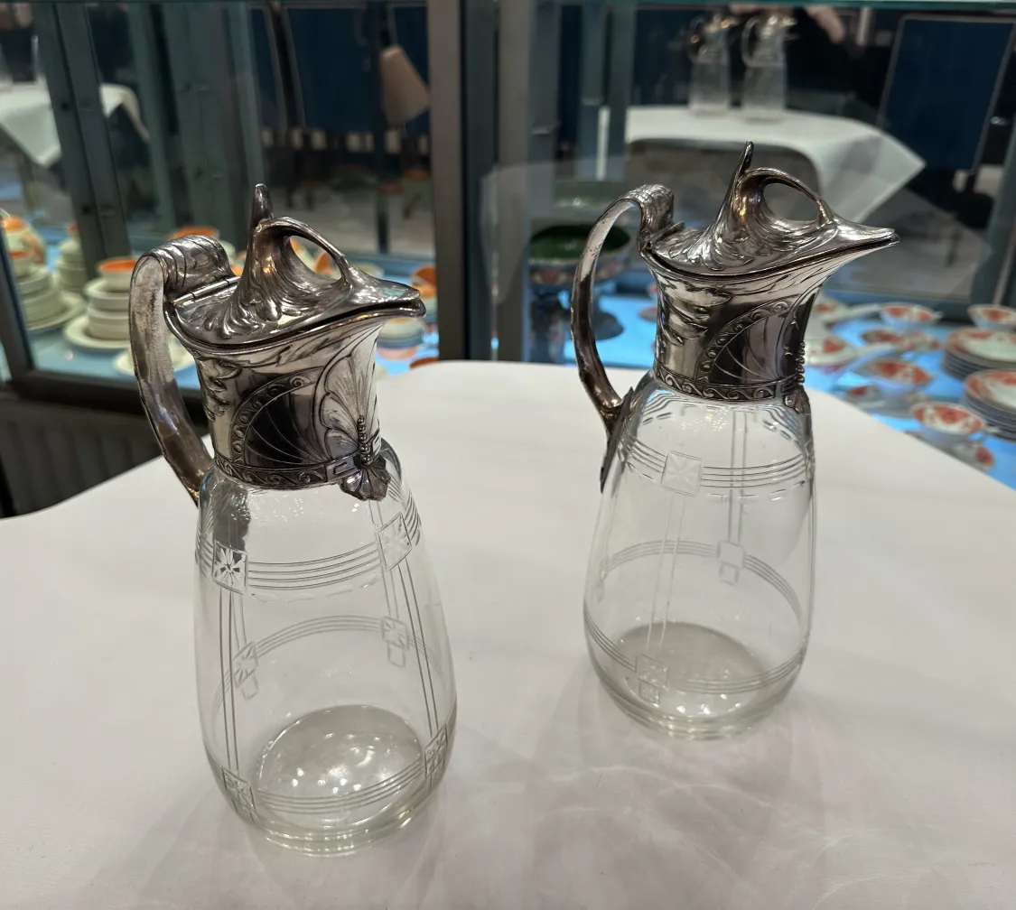Two antique WMF jars featuring decorative details and an elegant design in a classic setting.