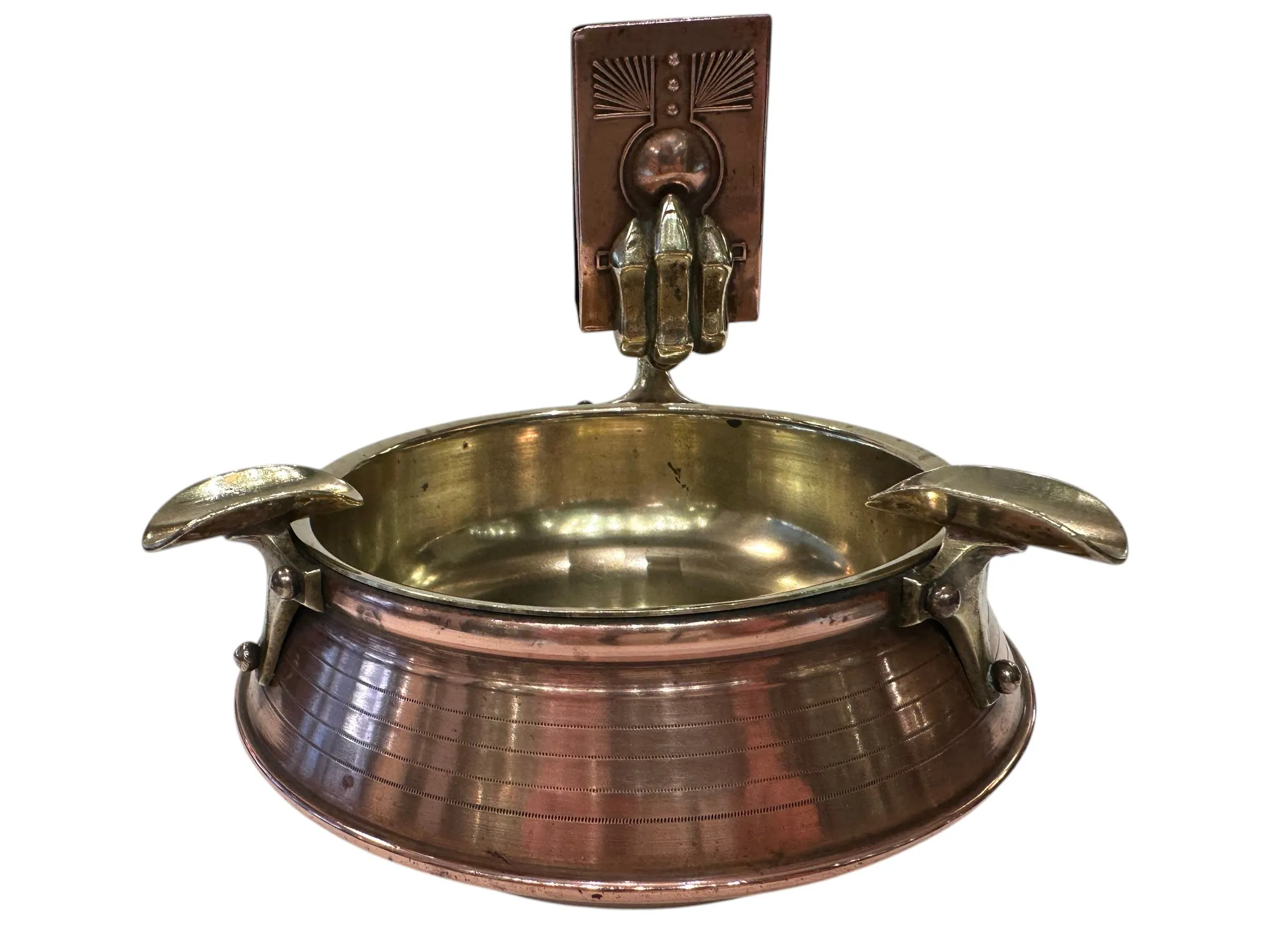 antique ashtray with decorative design and visible handles