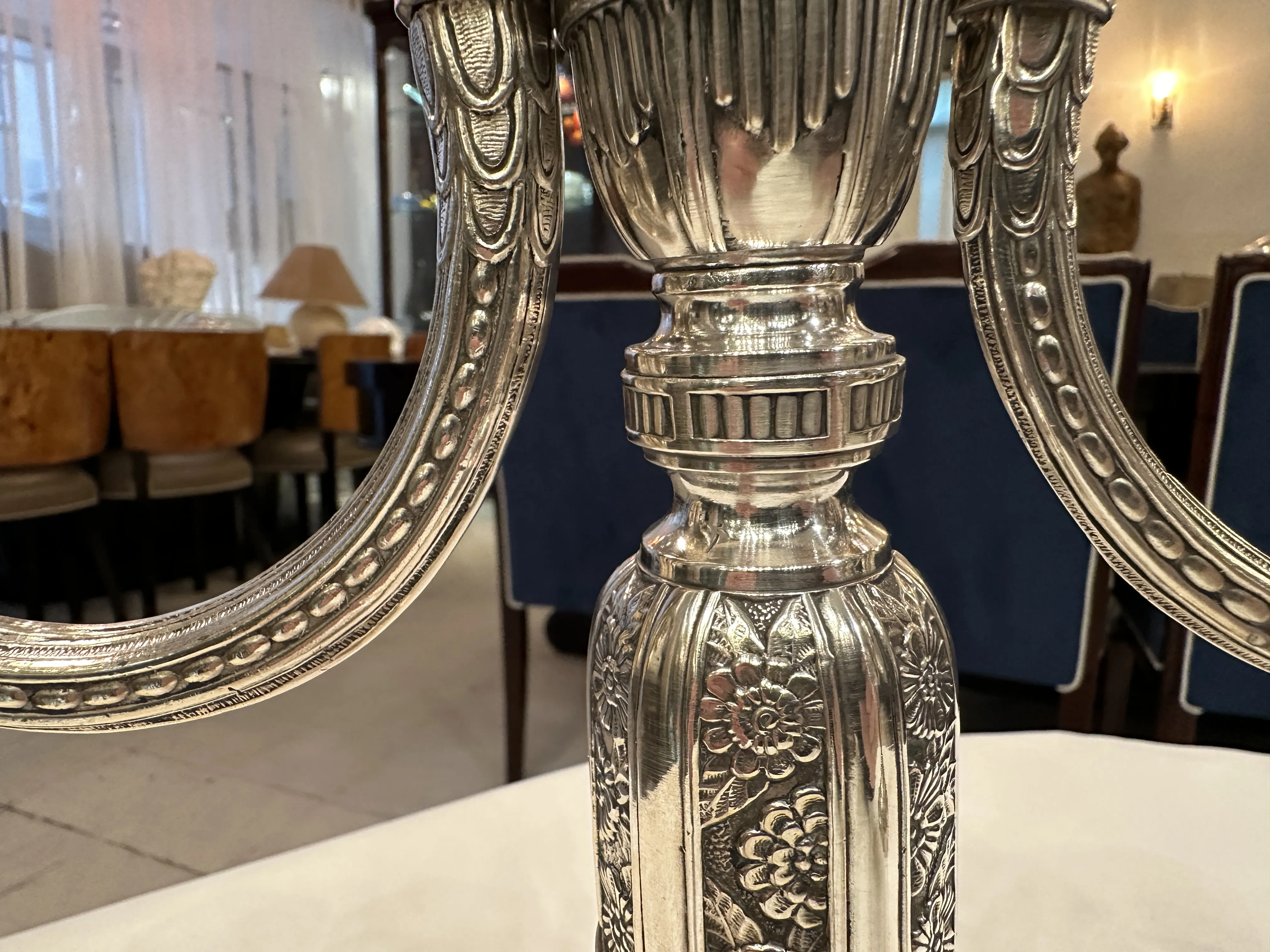 Antique candelabras with intricate decorative details in a cozy setting.