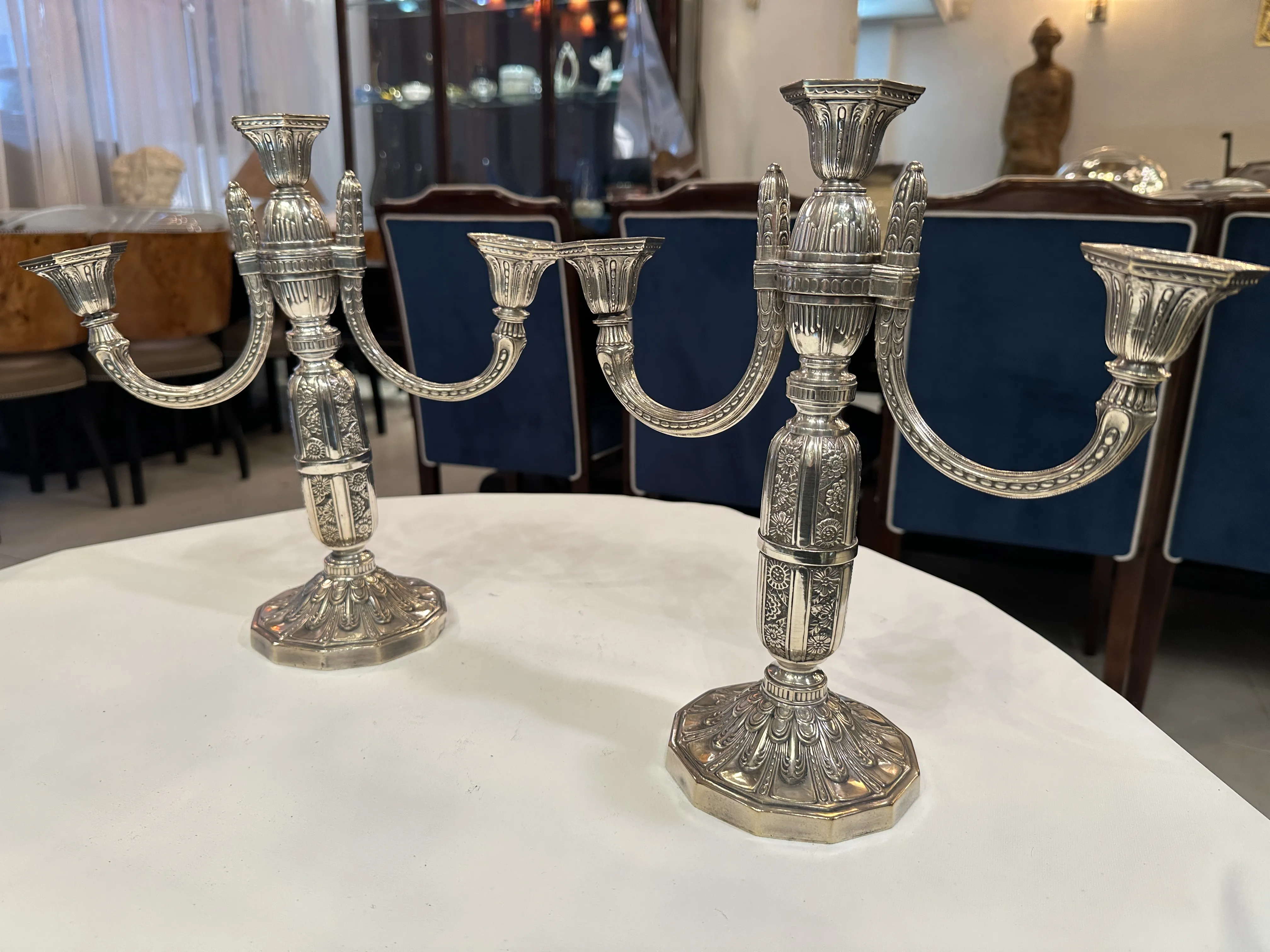 Two antique decorative candelabras on the table