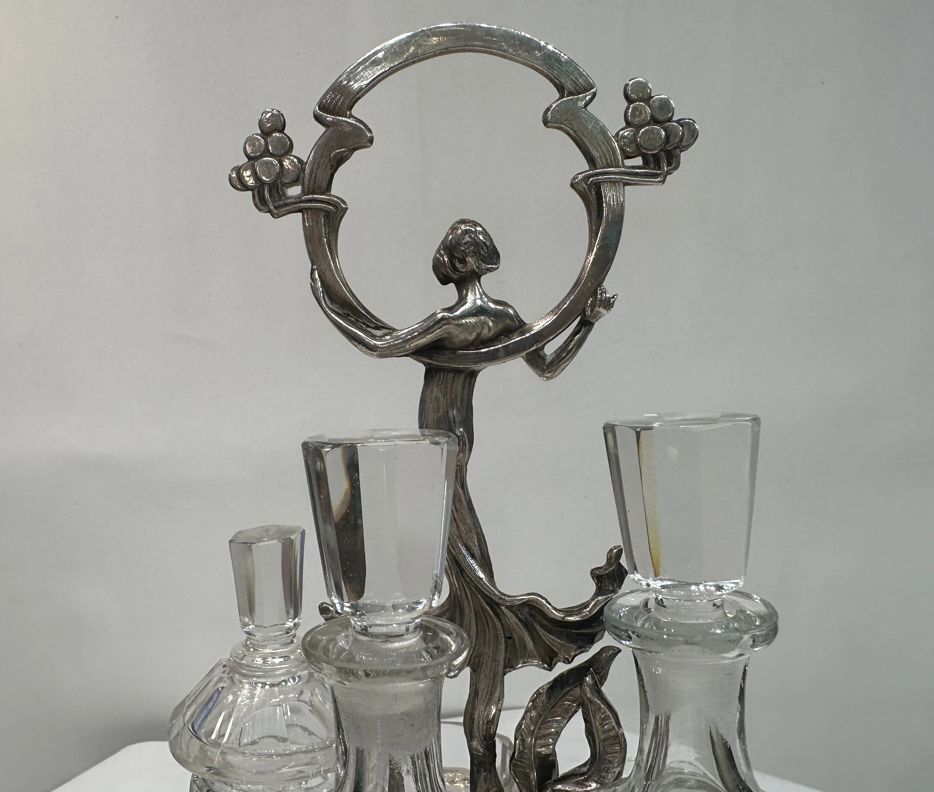 Antique salt shaker, pepper shaker, oil and vinegar set with decorative figure.