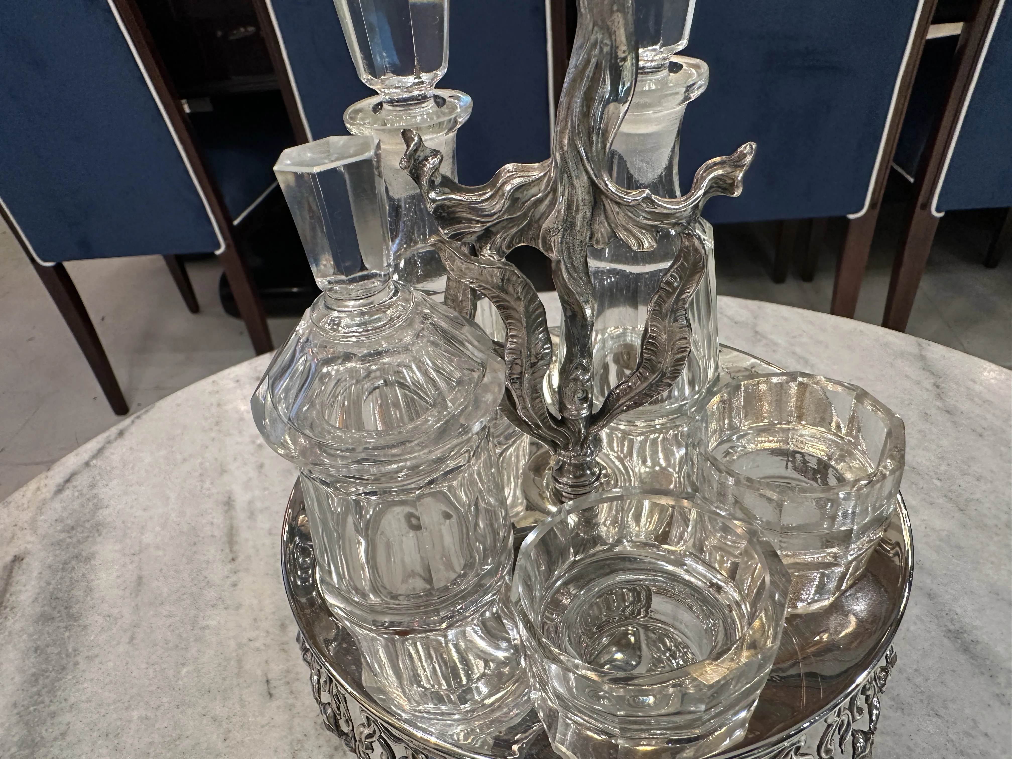 Antique salt shaker, pepper shaker, oil and vinegar set on display.