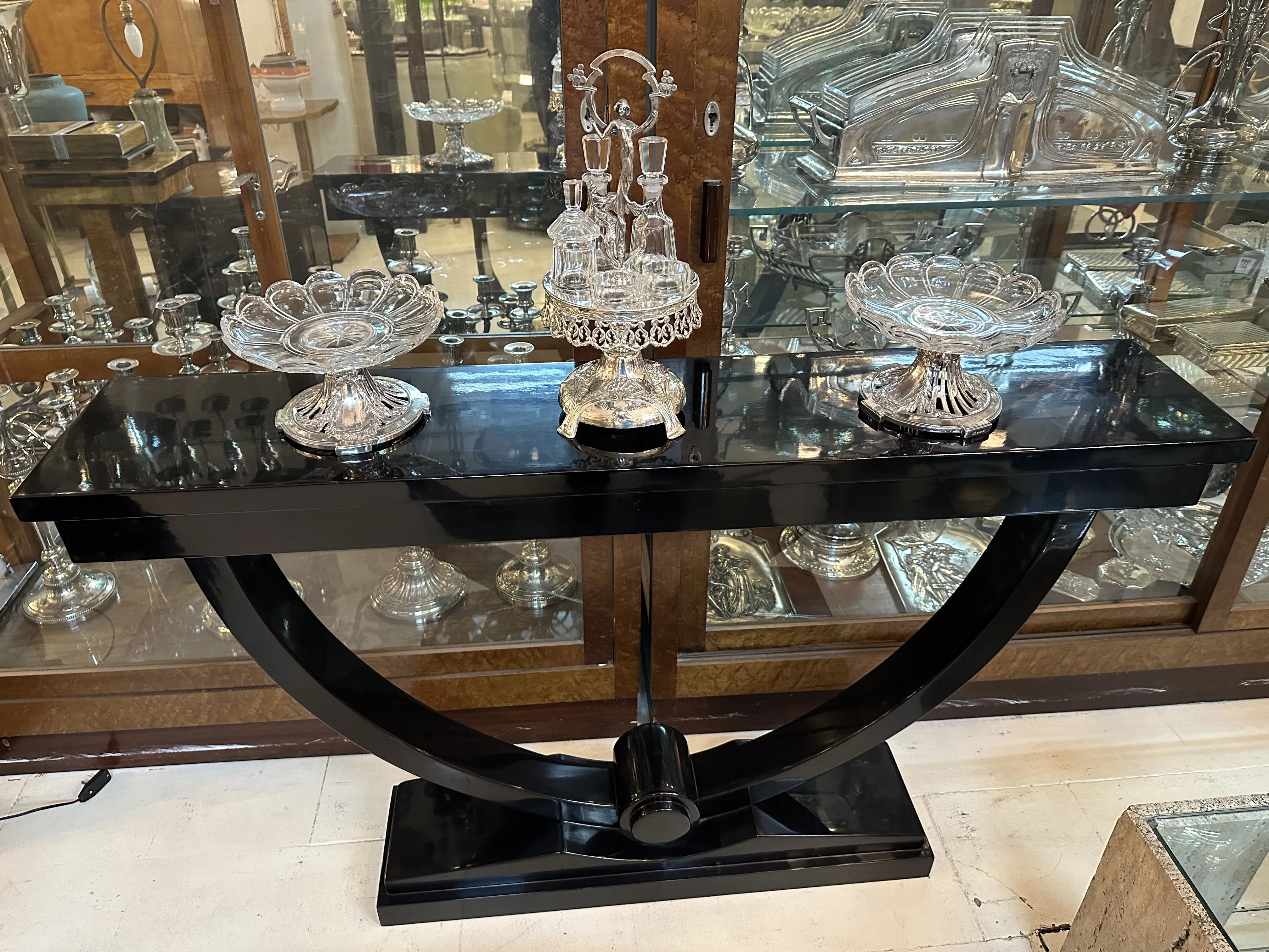 Antique salt shaker, pepper shaker, oil and vinegar set on black table.