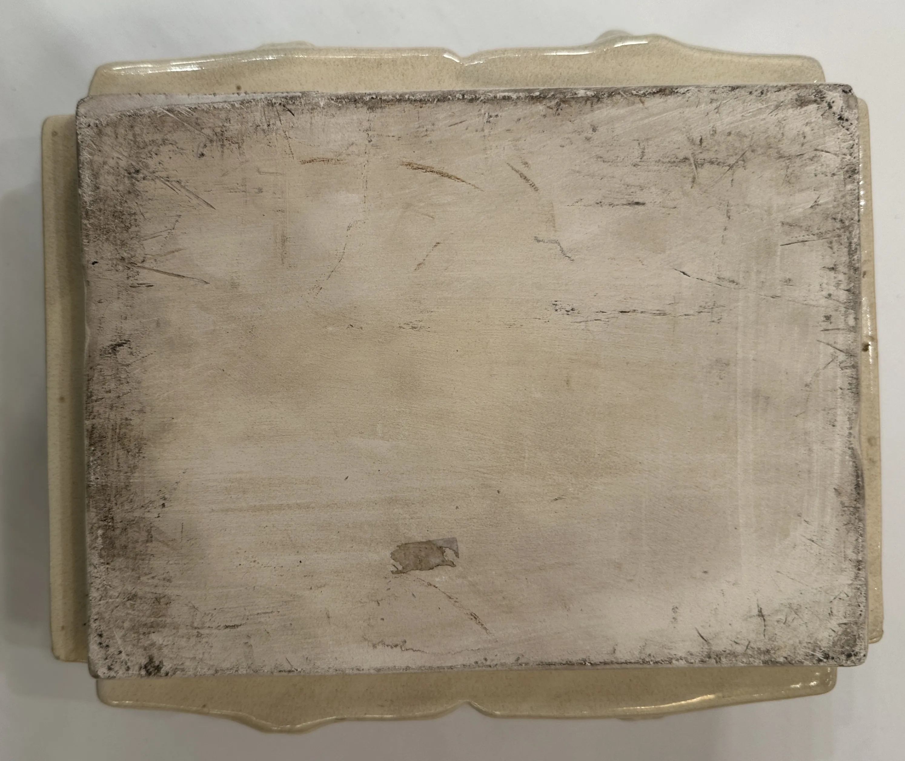 Ceramica antica con superficie usurata e segni visibili.