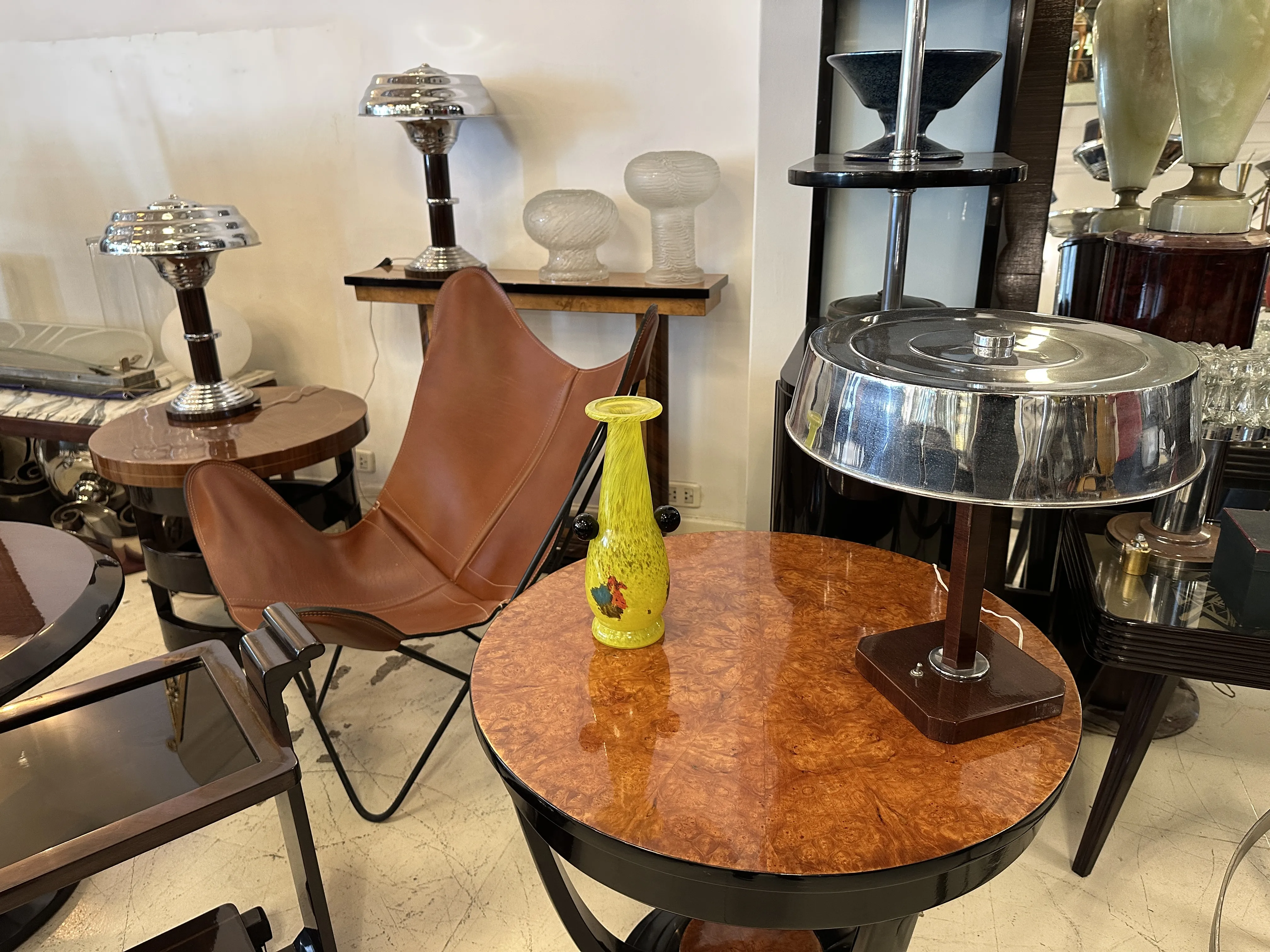 Antique signed glass by Schneider, featuring vibrant colors in a wavy form, amidst vintage furniture.