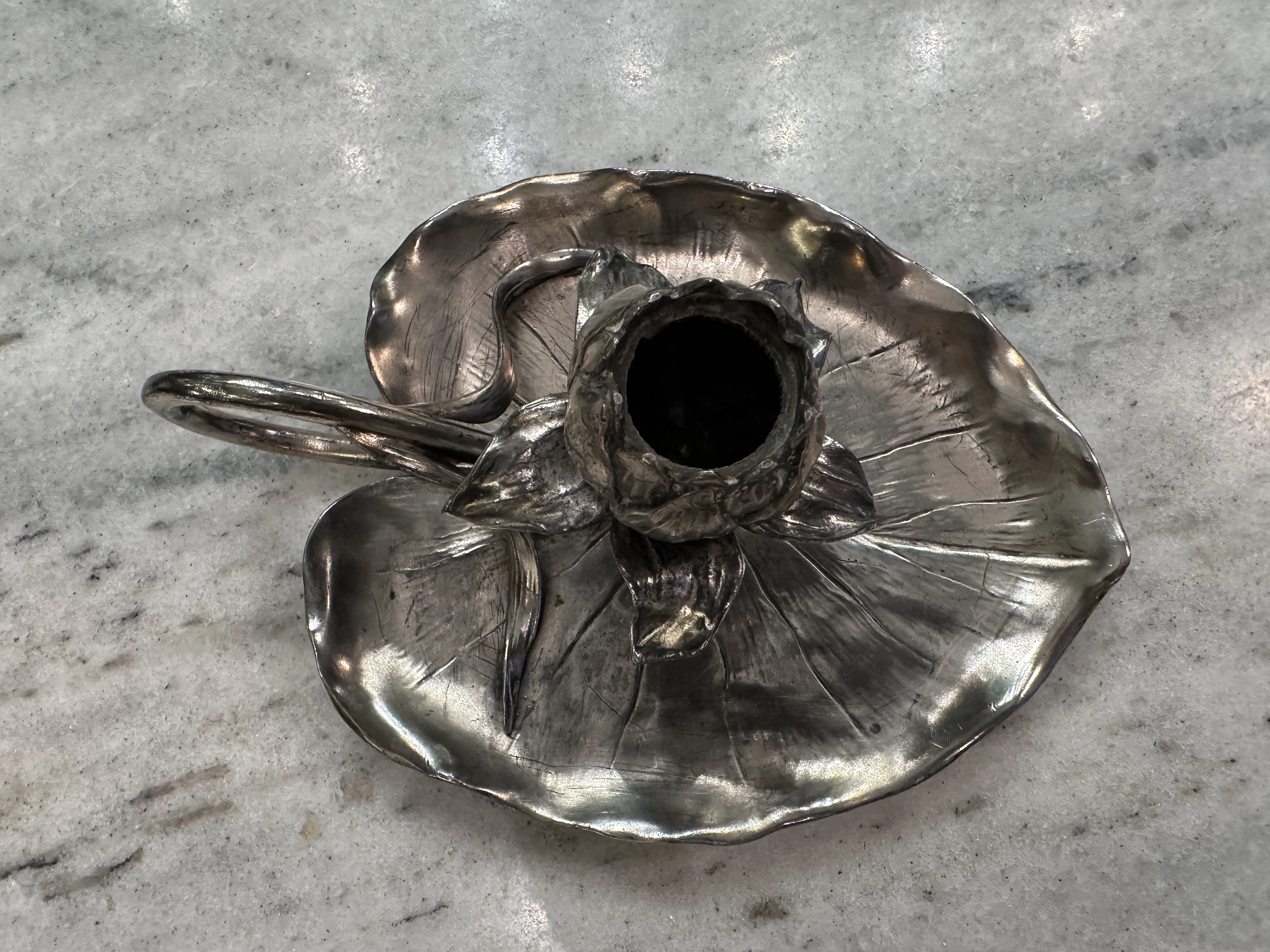 Antique candelabra shaped like a flower with leaf detail