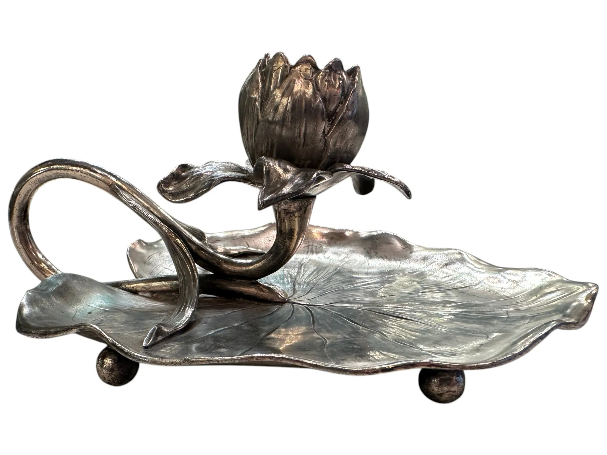 antique candelabra shaped like a flower on a leaf