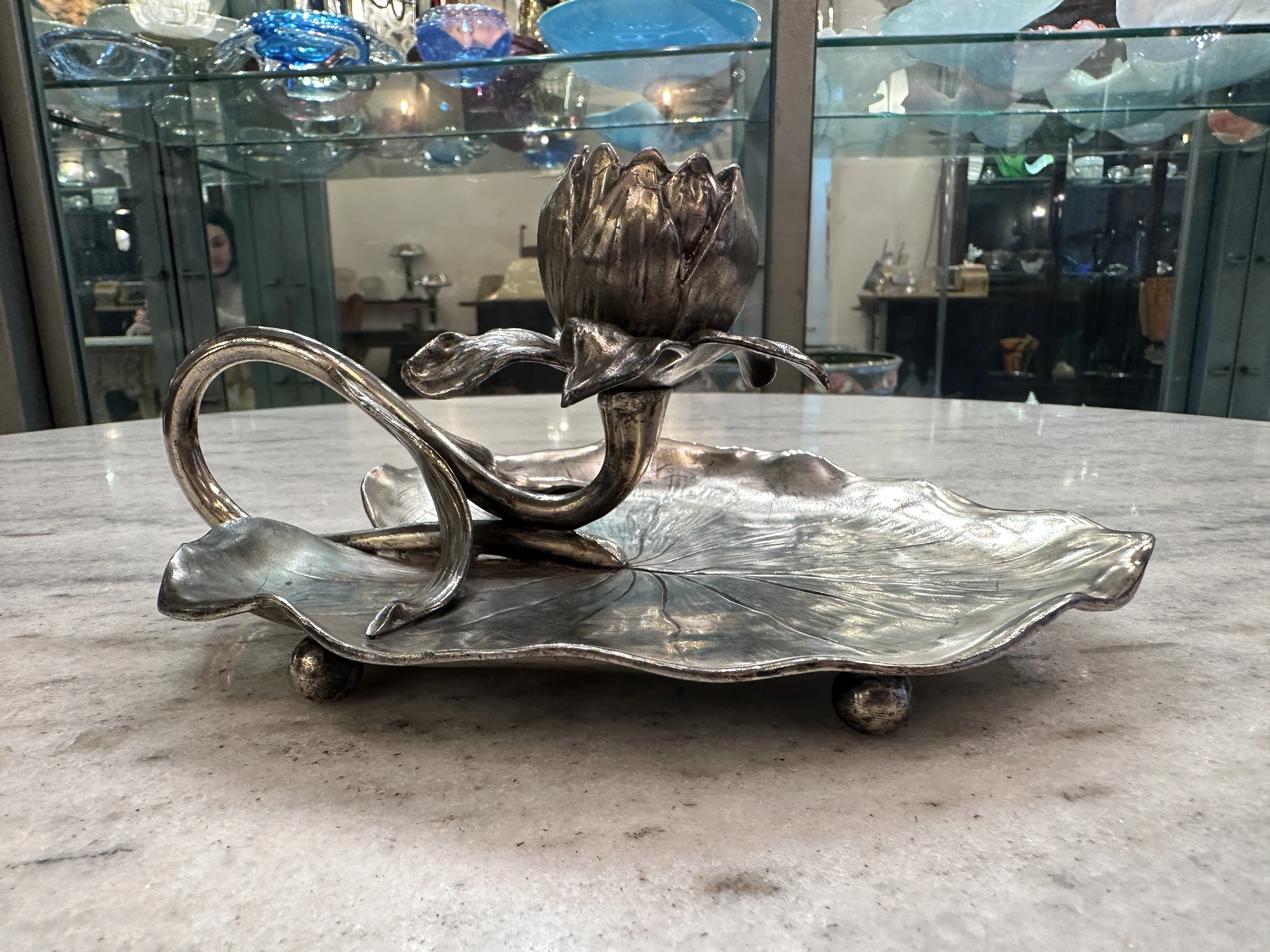 Antique candelabra shaped like a flower on a leaf