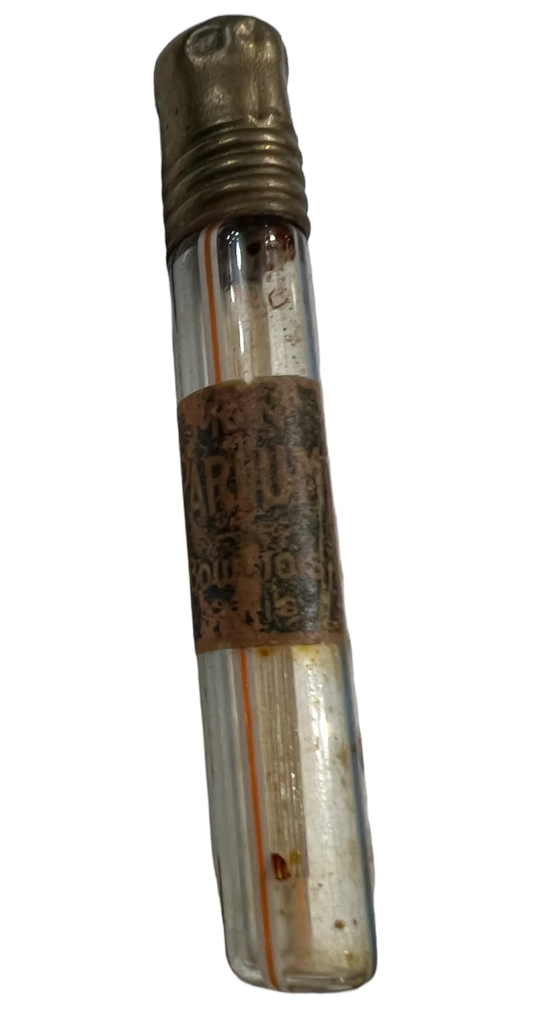 Frasco de perfume antigo com uma tampa dourada e etiqueta desgastada
