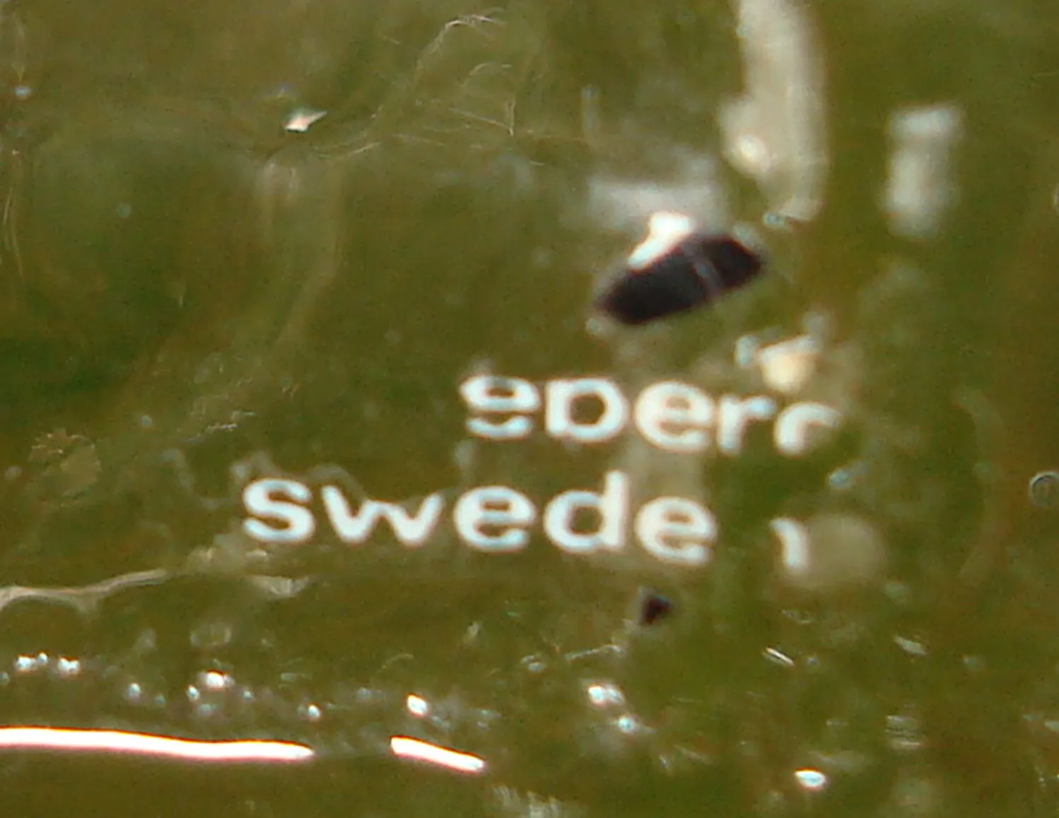 altes Siegel mit Pukeberg Sweden Aufschrift, grünem Hintergrund