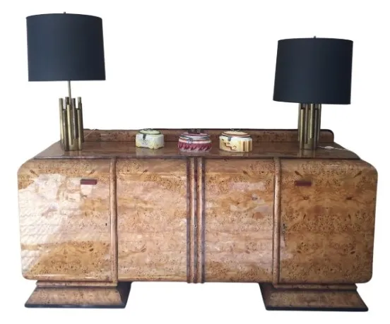 Antique sideboard with charming decor and elegant lamps on top.