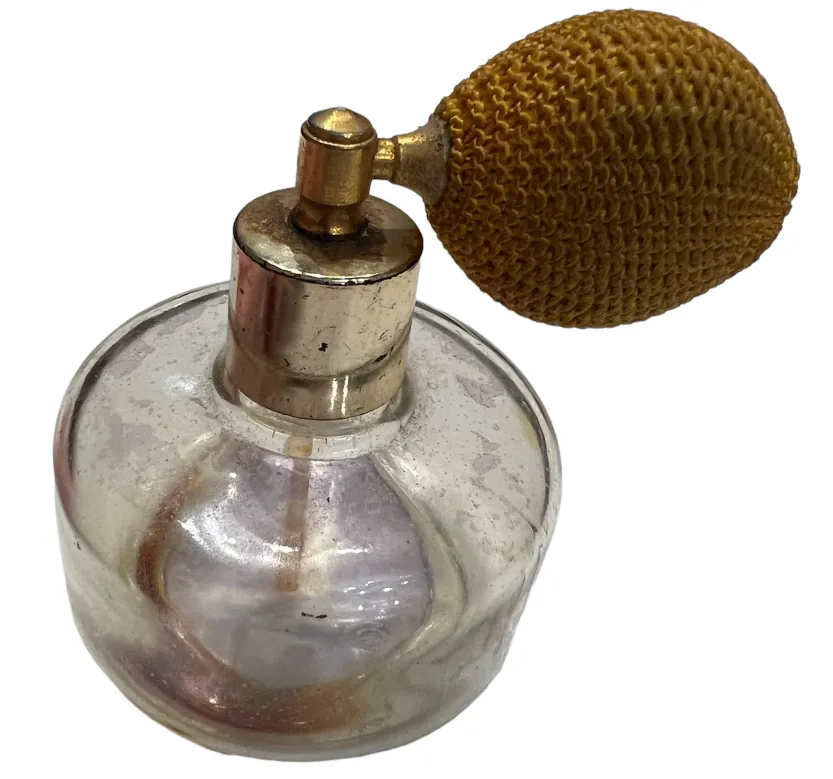 antique perfume bottle with round body and yellow spray