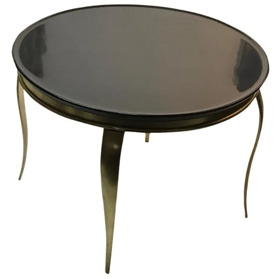 antique round coffee table with elegant legs, in a cozy setting.