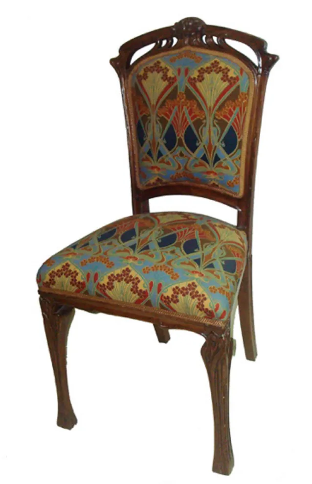 Antique chair with a beautiful colorful pattern on the upholstery.