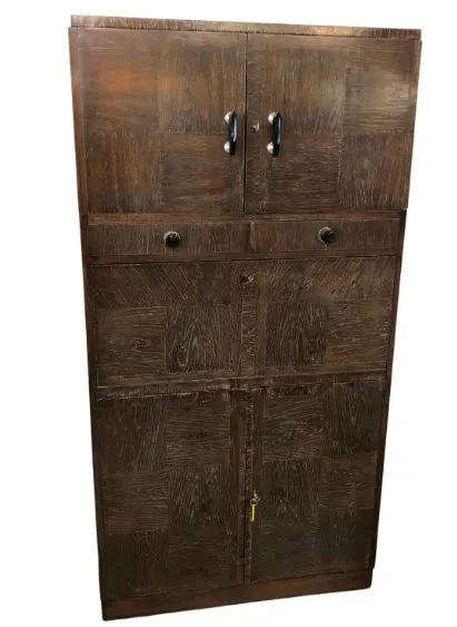 Antique wooden bar with two doors and drawers.