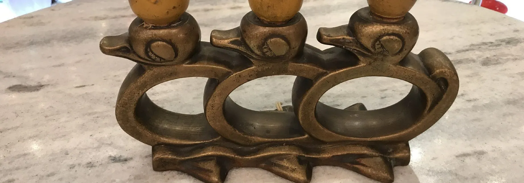Bronze candelabers featuring duck design on a table