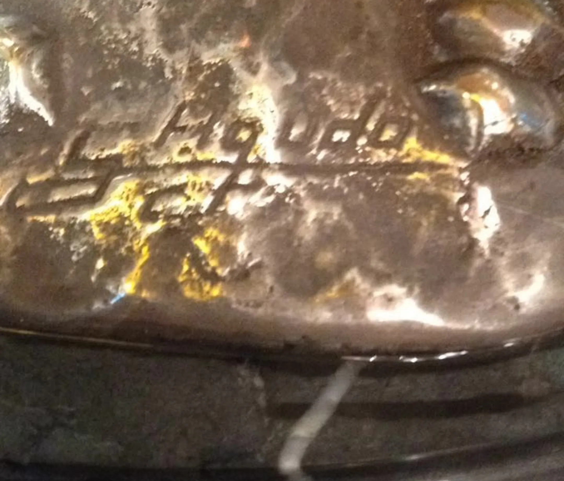 ancient Sagudo seal with textured details in a dark setting