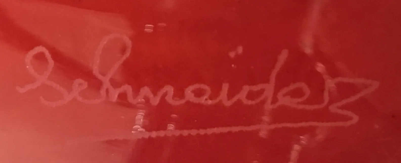 antique seal with Schneider signature on red background