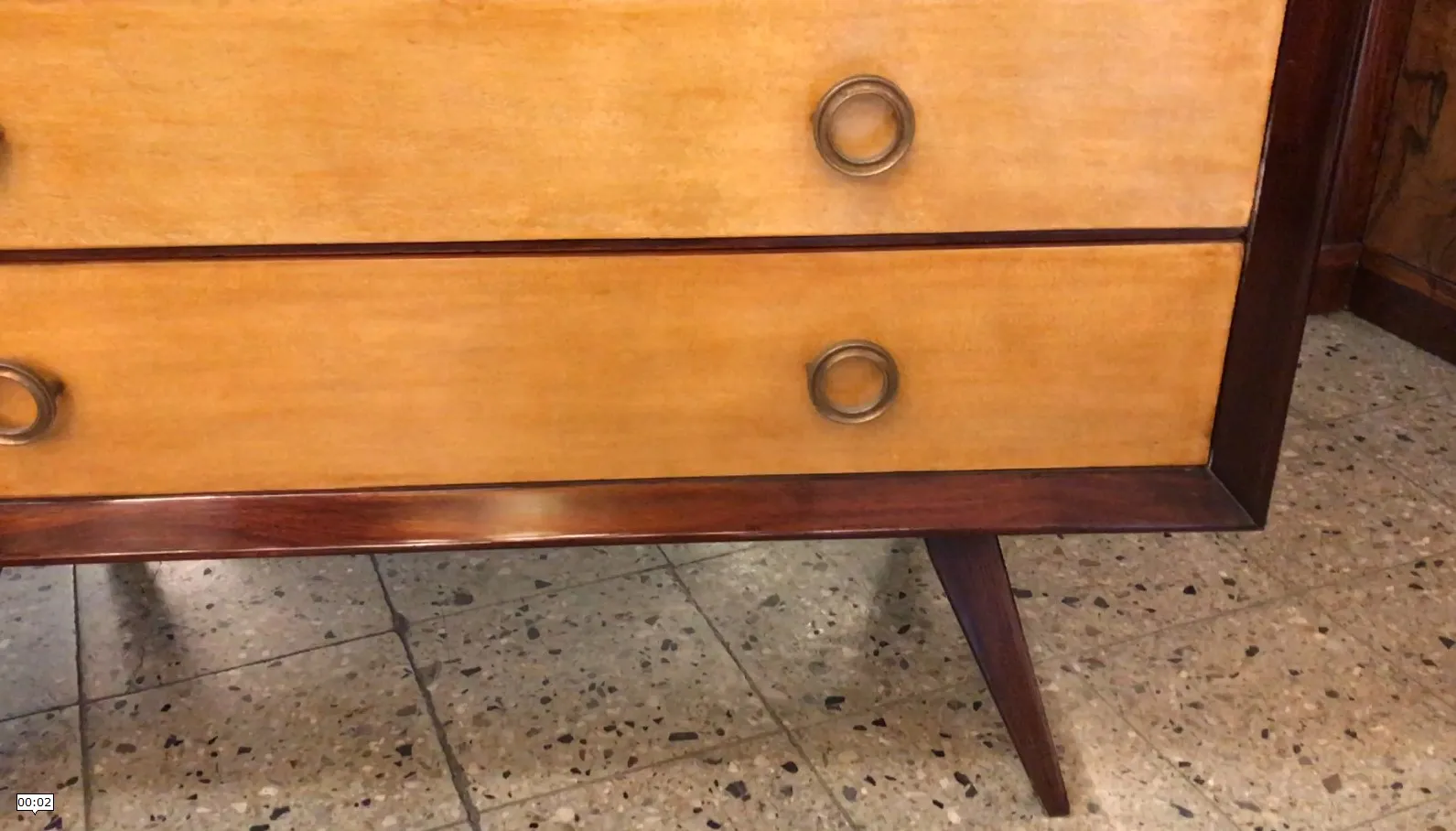 Antique wooden cabinet with two drawers and metal handles.