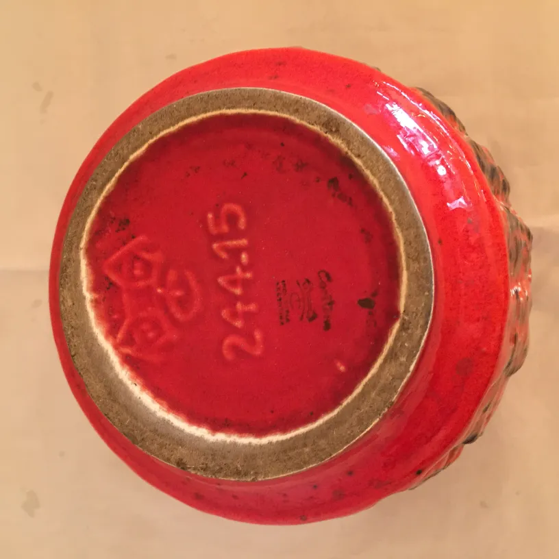 Top view of an antique red ceramic with details.