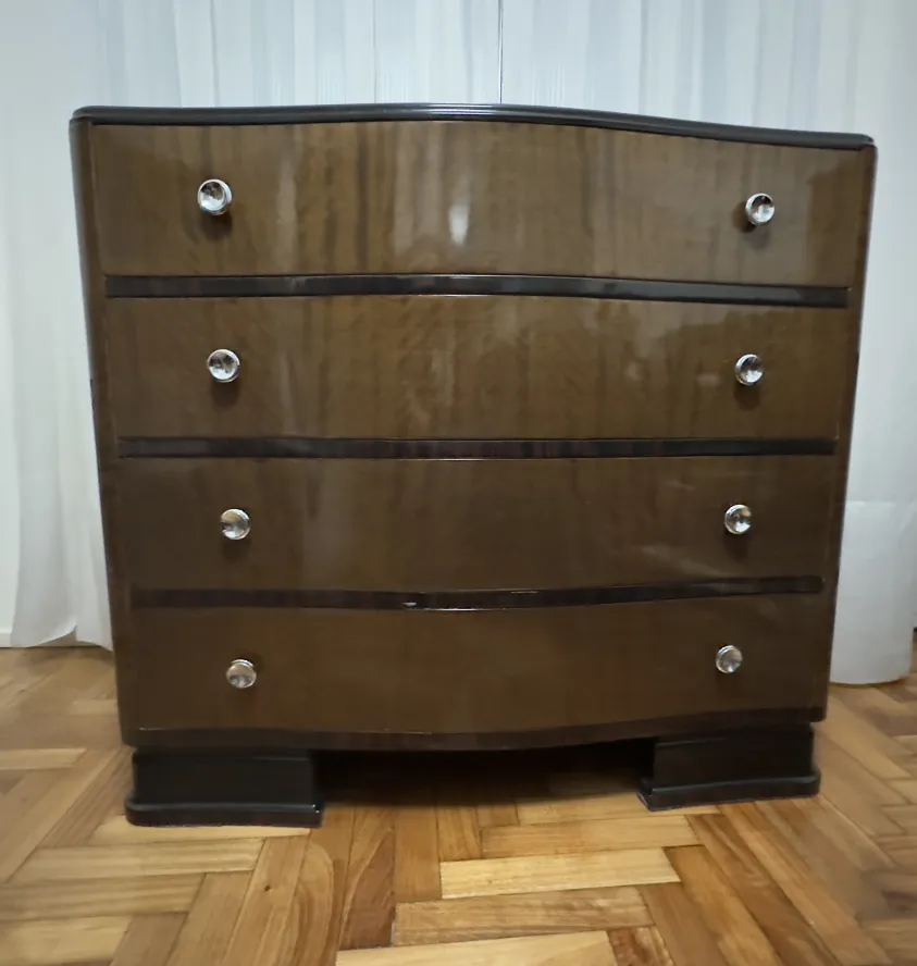 Antique cabinet with shiny finish and elegant handles