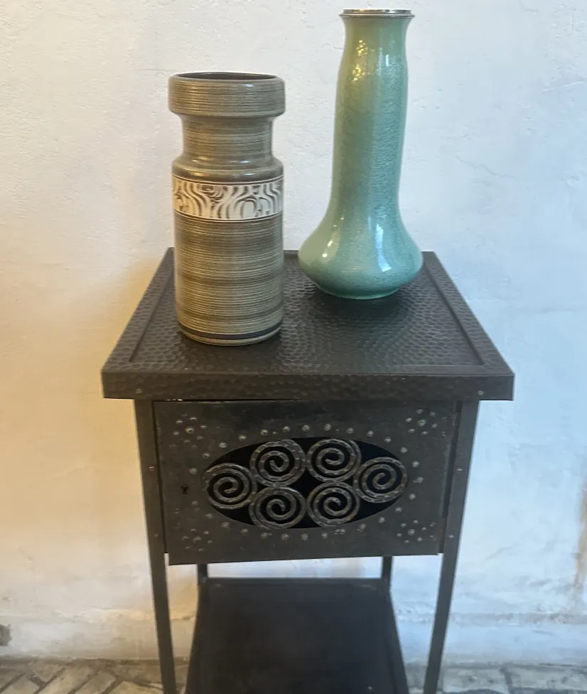 ancient ceramic vases on dark table