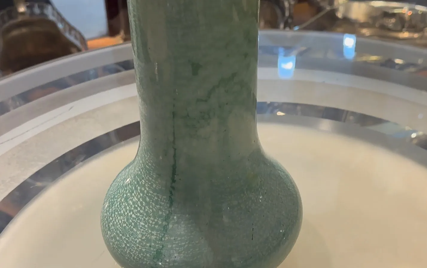 Antique green ceramic cup with shiny texture
