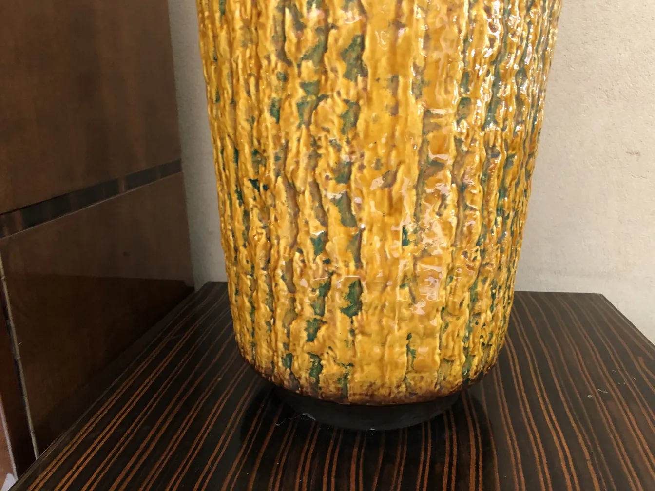 antique yellow ceramic vase with textured surface