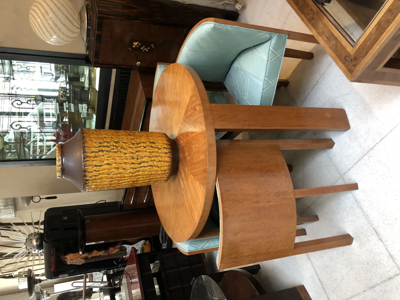 Antique ceramic vase with golden texture on wooden table.