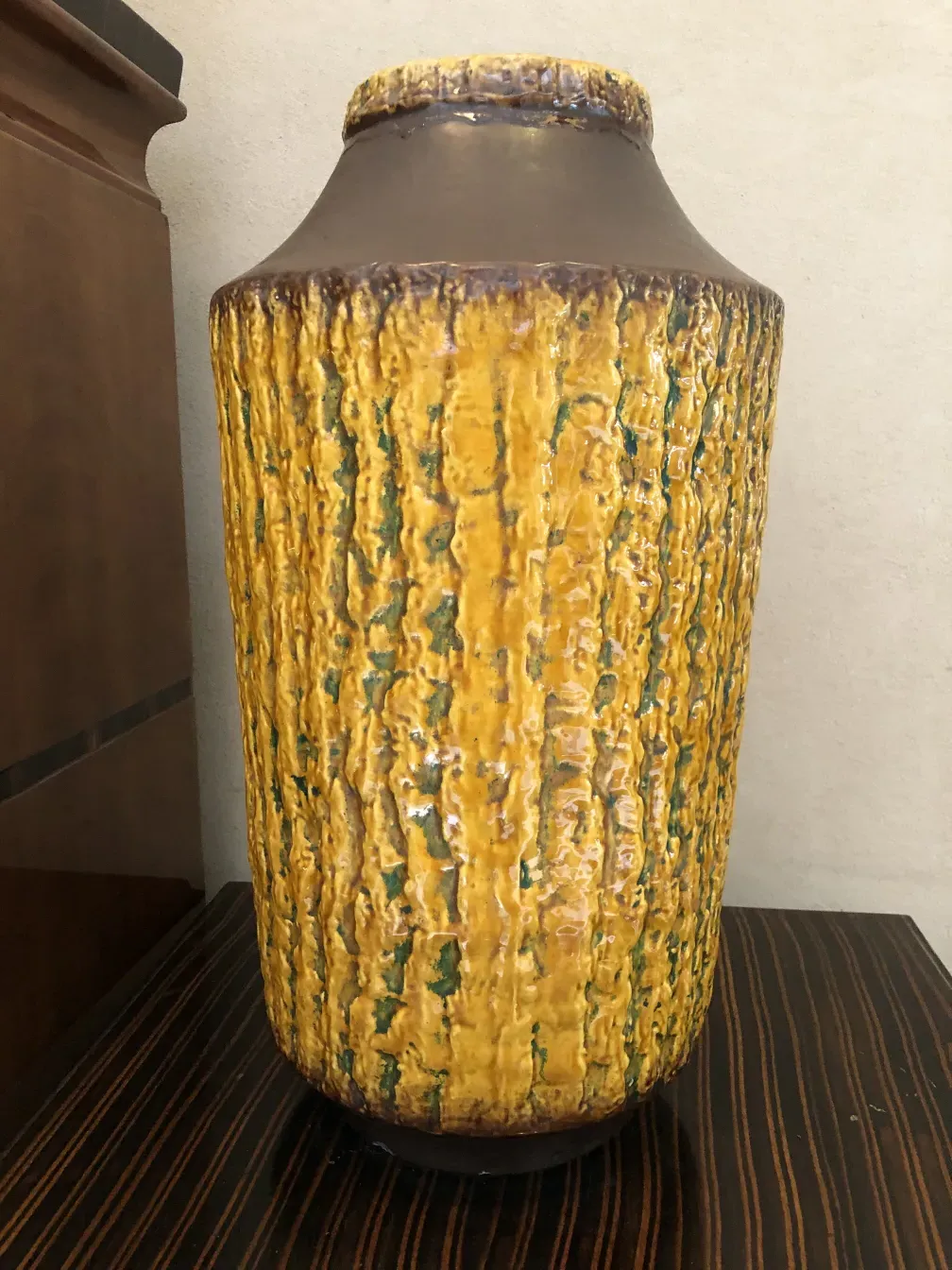 antique decorative ceramic vase with yellow and green textures.