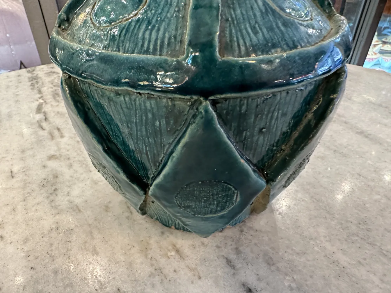 Antique ceramic vase in textured blue tones.