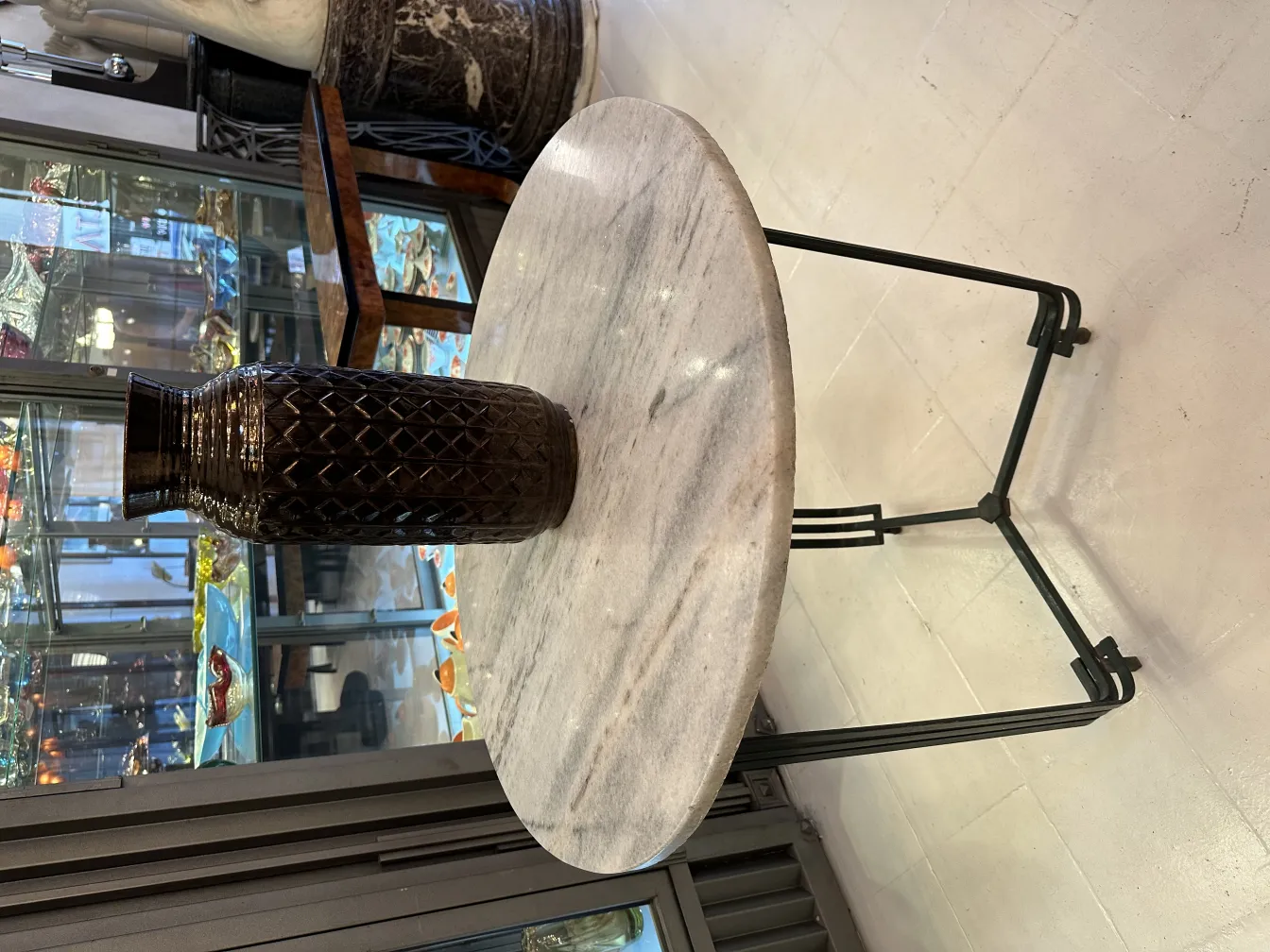 Antique brown decorative ceramic vase on a marble table. Elegant setting.
